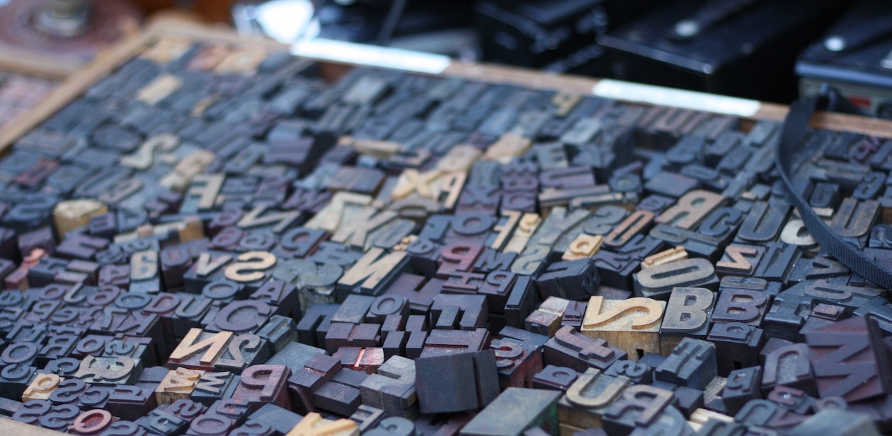 a box full of jumbled letter press letters