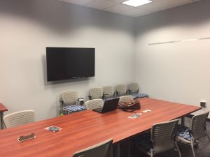 Digital humanities lab interior, showing conference table and flat screen